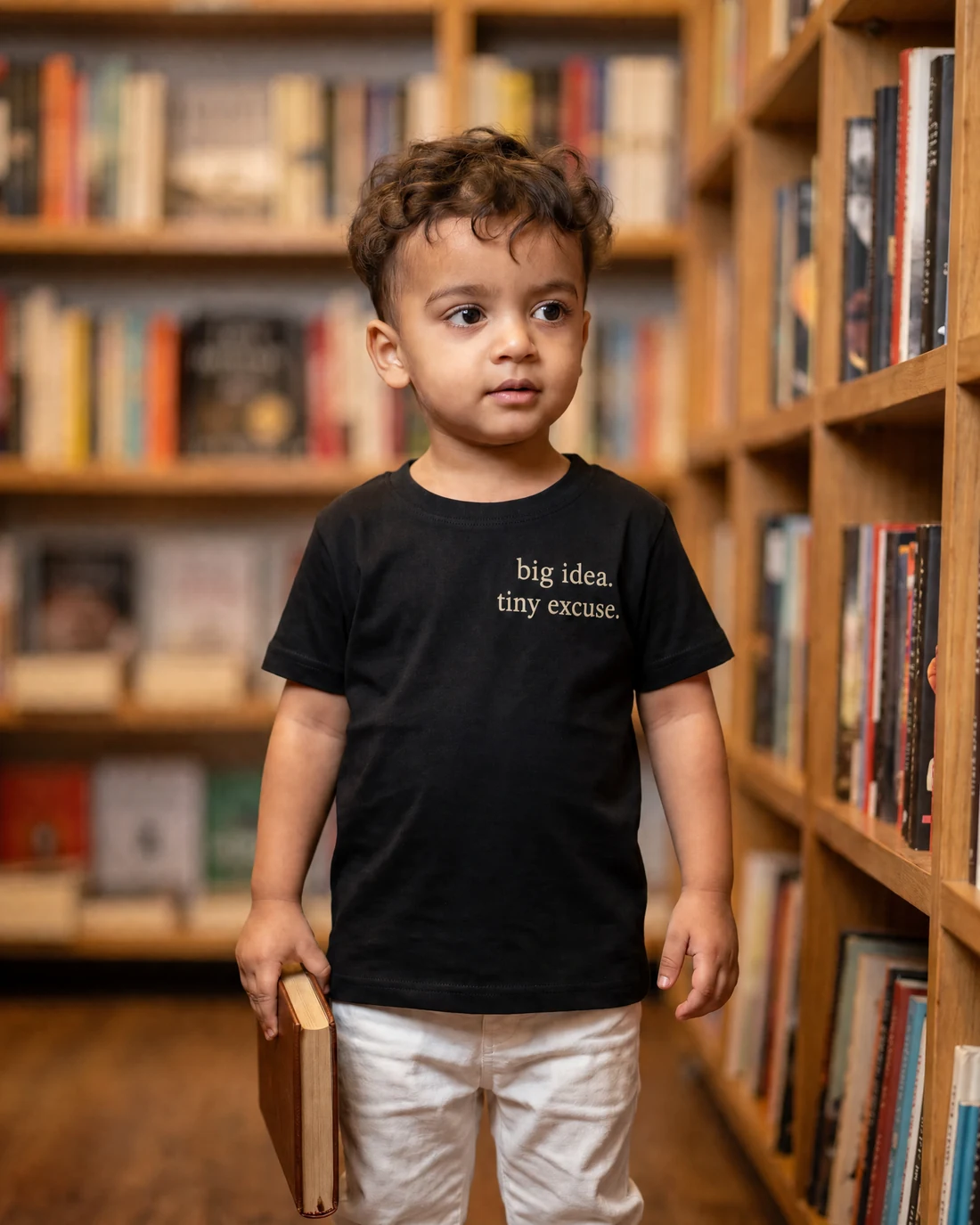 Kabir wearing the Boys Big Idea Tiny Excuse Editor’s Mark with the exact statement “big idea. tiny excuse.” printed into the garment.