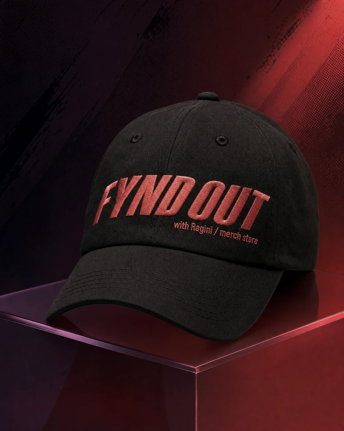 Six-panel cap photographed as a real premium object with the original FYND OUT with Ragini merch-store wordmark integrated into its material.