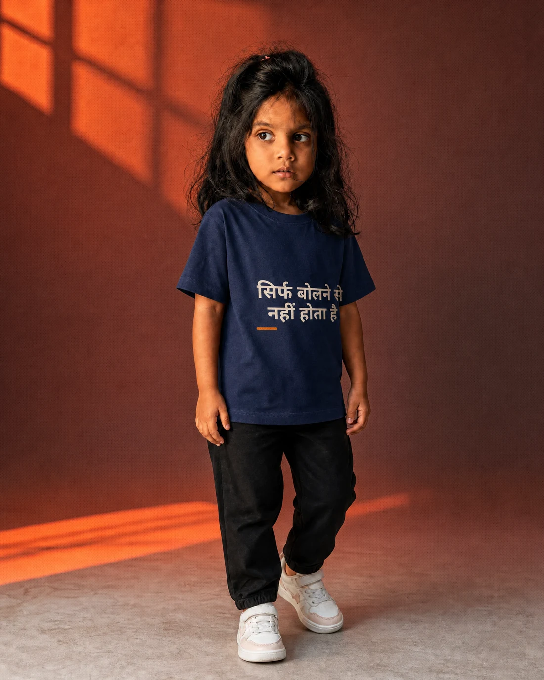 Aarya wearing the Girls सिर्फ बोलने से नहीं होता है Editor’s Mark with the exact statement “सिर्फ बोलने से नहीं होता है” printed into the garment.