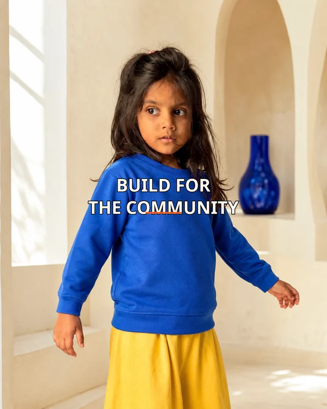 Aarya wearing the Girls So Build For The Community Panel Drop featuring the exact statement “so build for the community”.