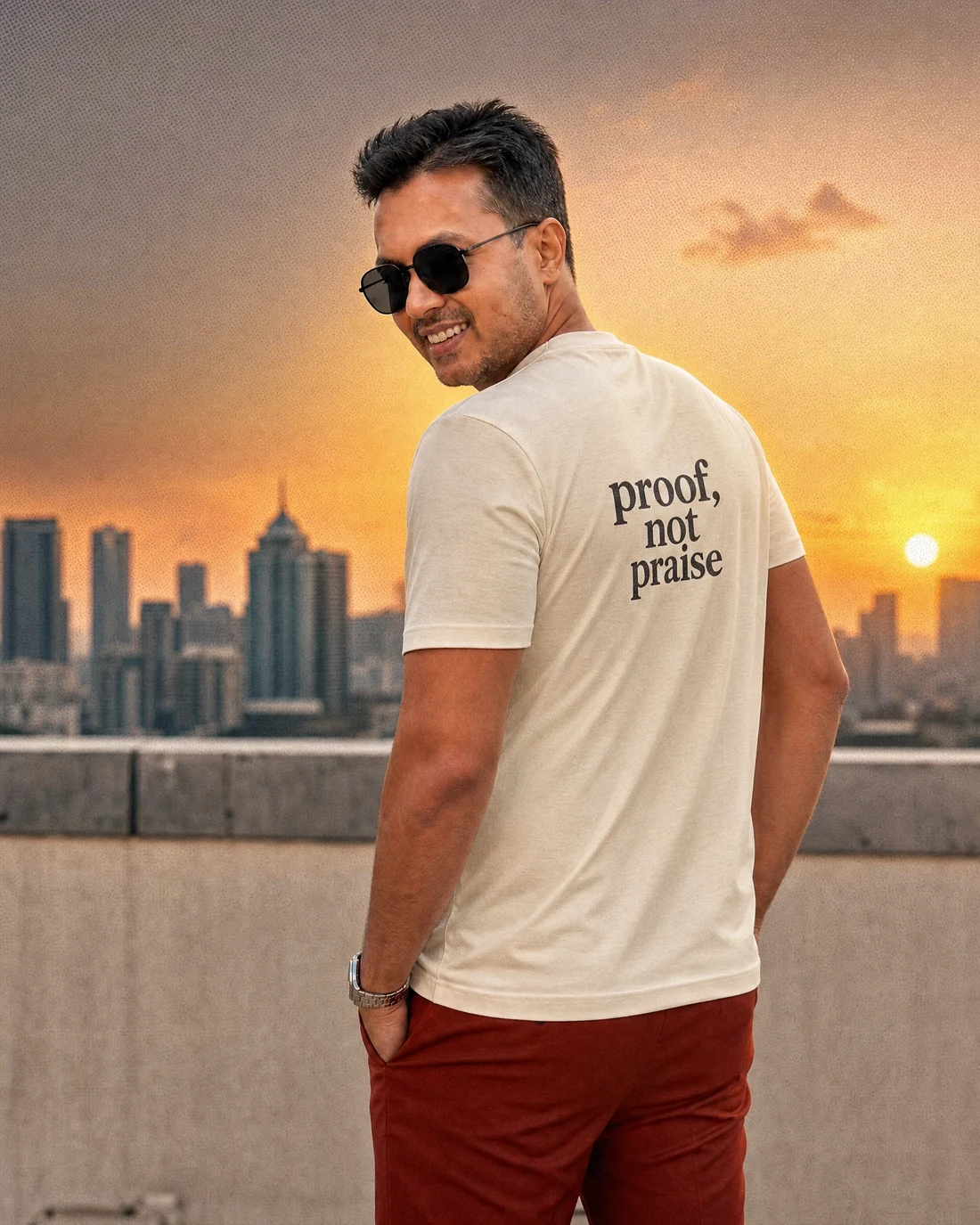 Farooq wearing the Men Proof Not Praise Backstory with the exact statement “proof, not praise” printed into the garment.