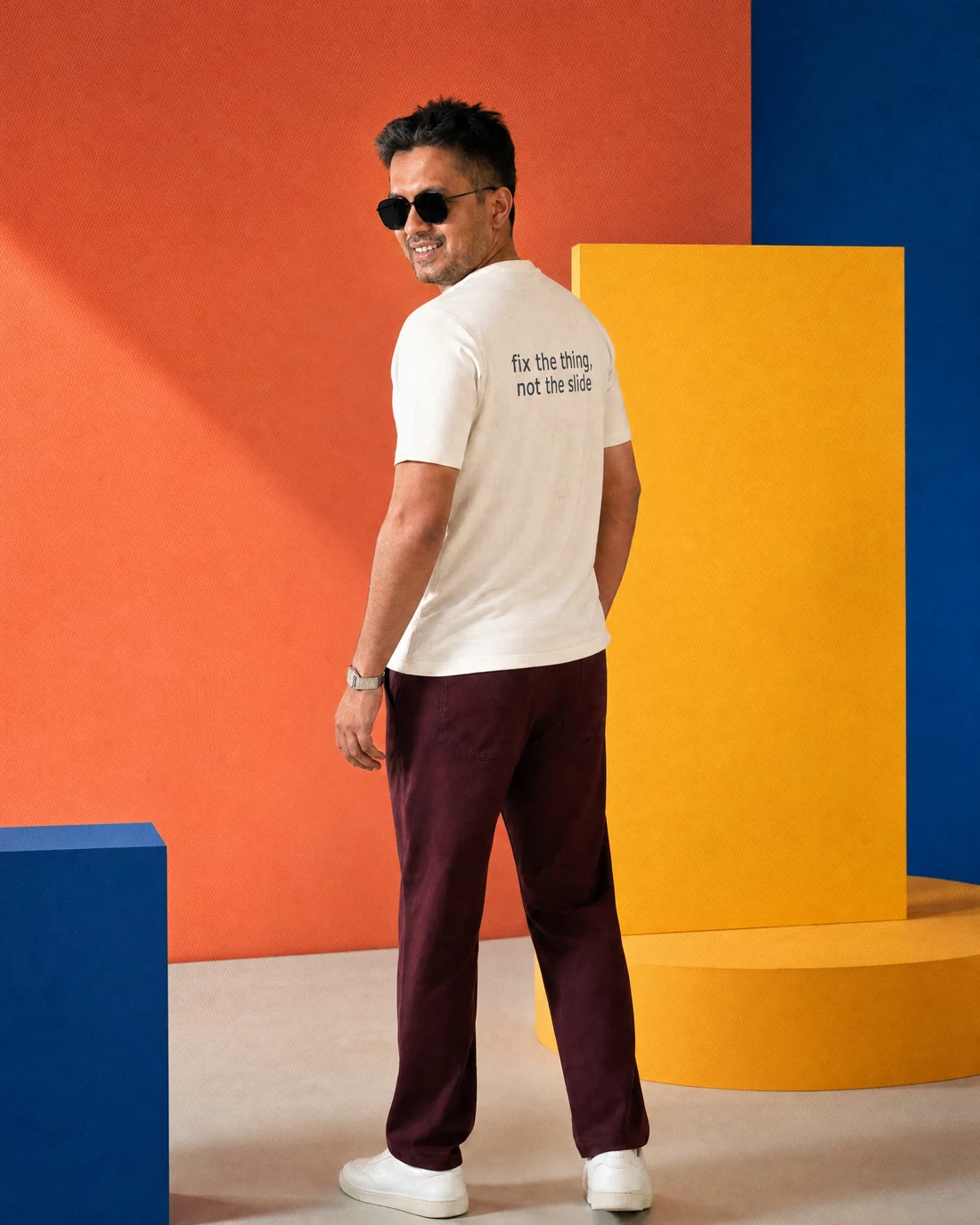 Farooq wearing the Men Fix The Thing Not The Slide Backstory with the exact statement “fix the thing, not the slide” printed into the garment.