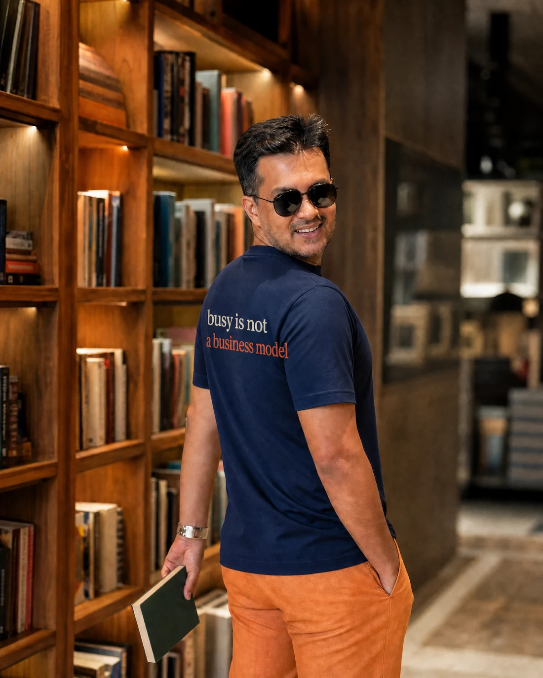 Farooq wearing the Men Busy Is Not A Business Model Backstory with the exact statement “busy is not a business model” printed into the garment.