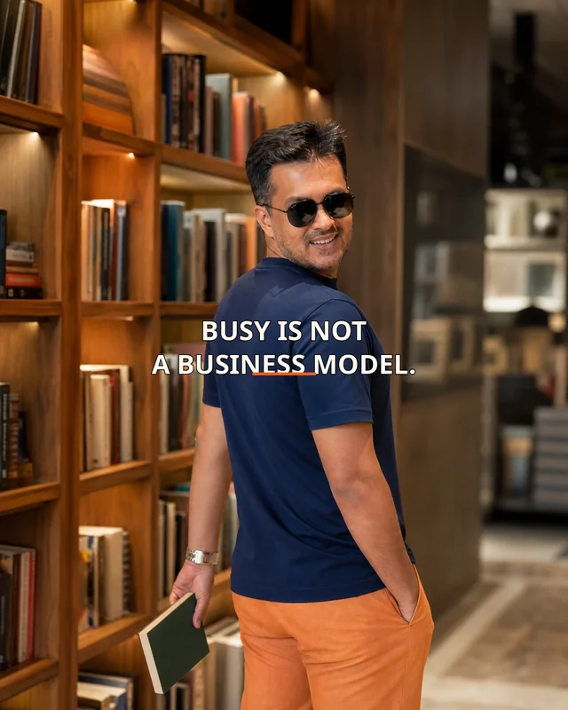 Farooq wearing the Men Busy Is Not A Business Model Backstory featuring the exact statement “busy is not a business model”.