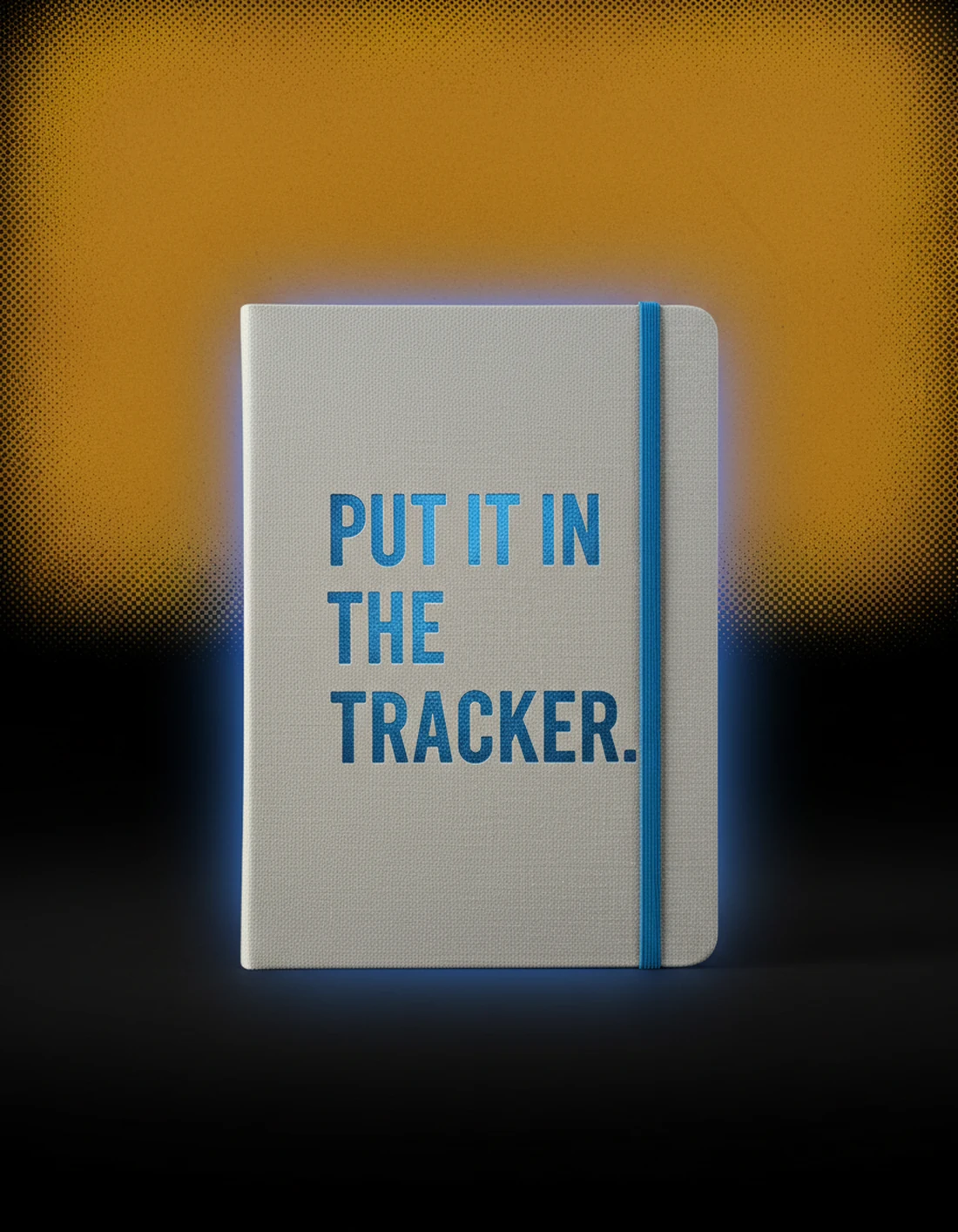 Cloth-bound notebook photographed as a real premium object with the exact statement “put it in the tracker” integrated into its material.