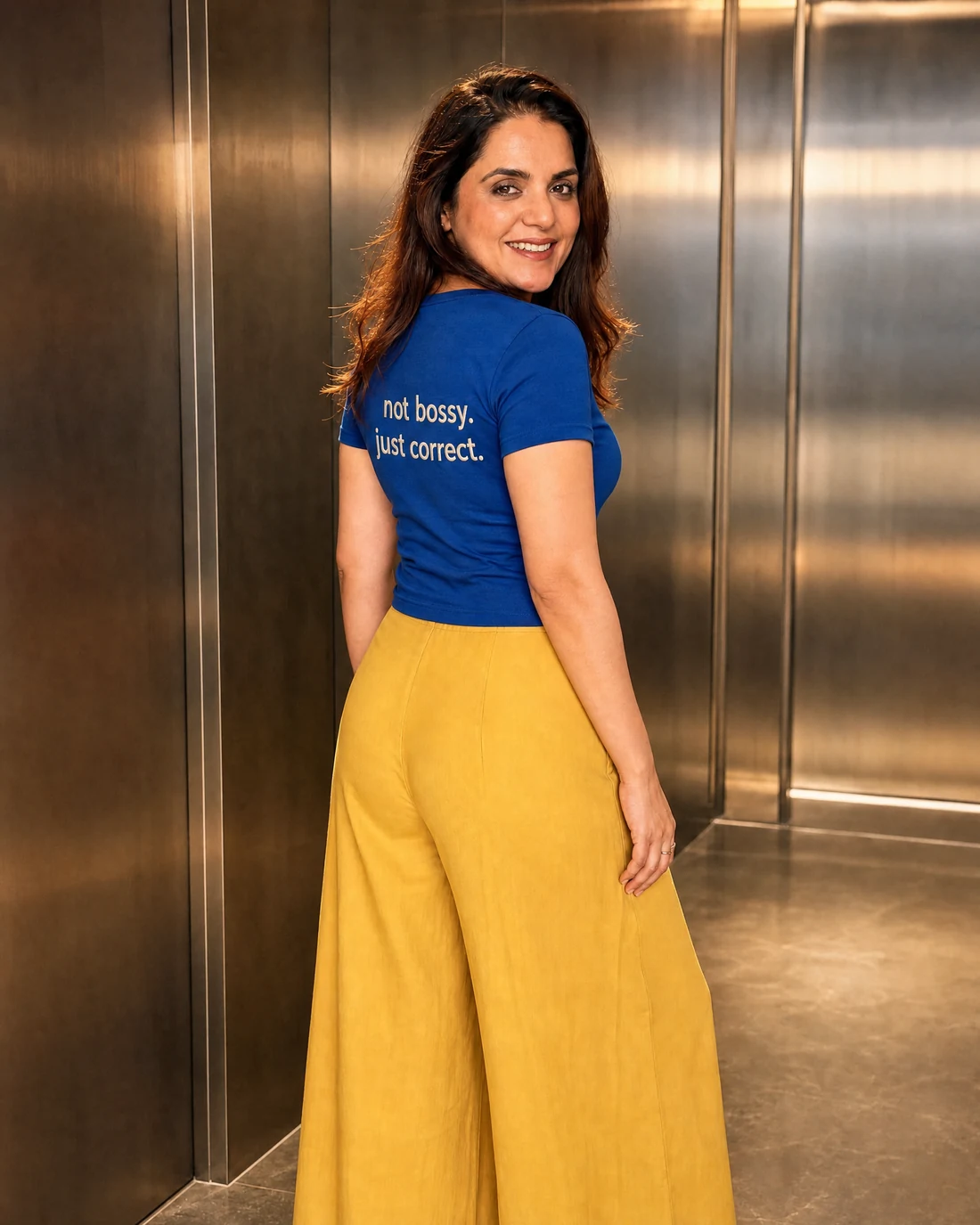 Ragini wearing the Women Not Bossy Just Correct Backstory with the exact statement “not bossy. just correct.” printed into the garment.